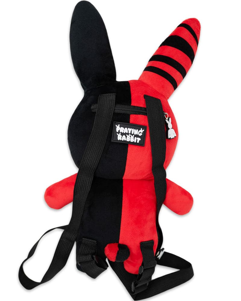 back view of red and black rabbit plushie that shows the praying rabbit logo and backpack straps