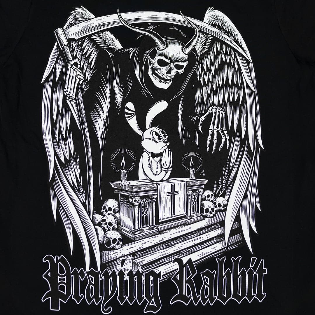 praying rabbit on an altar with a huge guardian angel behind him. the guardian angel has an even skull face with horns. he has huge wings and is holding a scythe watching over the praying rabbit. the design is old cartoon style. there's text at the bottom the reads praying rabbit