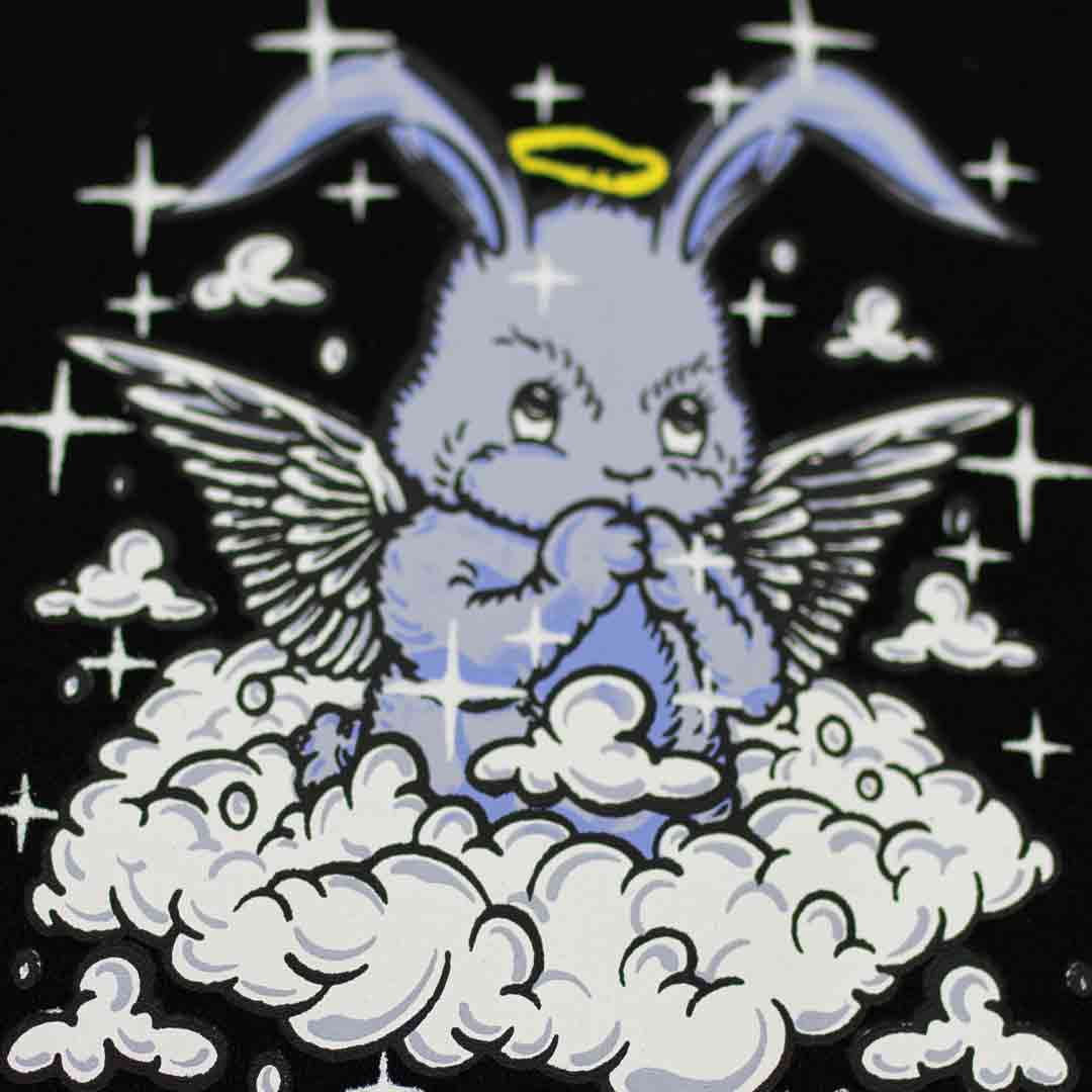 baby blue praying rabbit with angel wings floating on a cloud. there is a halo above the rabbit's head and sparkles around him