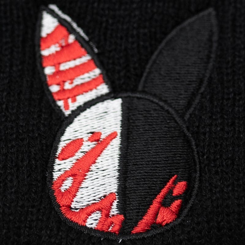 close up of embroidered design that shows black and white rabbit head with red blood splattered on it