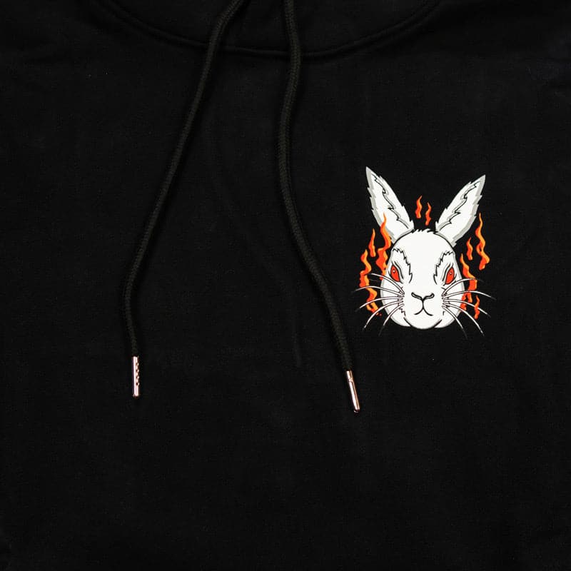 close up of white rabbit head with flames behind him