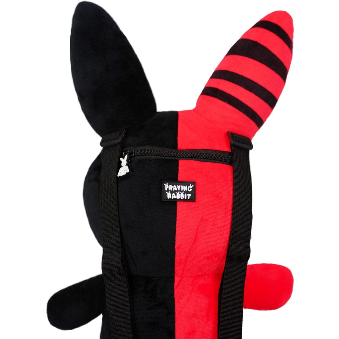 close up view of cute bunny grunge plushie bag that shows the rubber label of praying rabbit