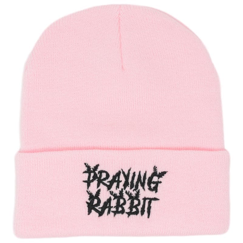 light pink beanie with an embroidered praying rabbit distressed logo
