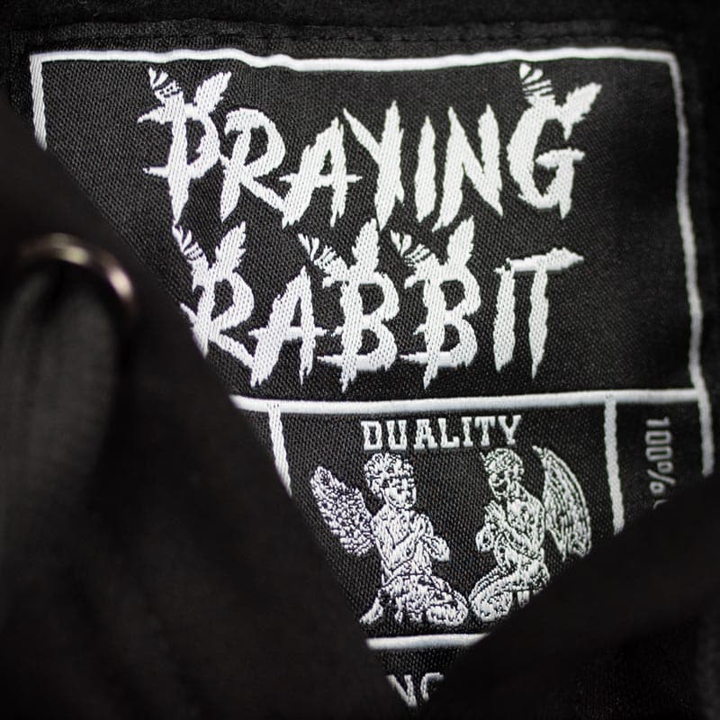 praying rabbit duality woven labels with a design of an angel and demon
