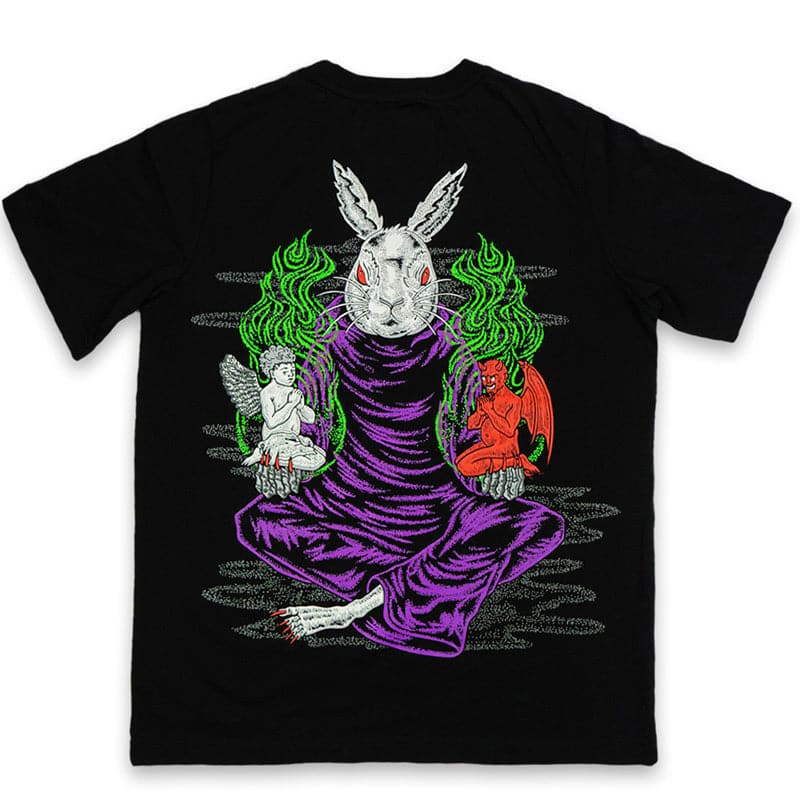 back view of black t shirt with a printed design of an evil white rabbit in purple robes, sitting with its legs crossed. there's a demon in one hand and an angel in the other hand