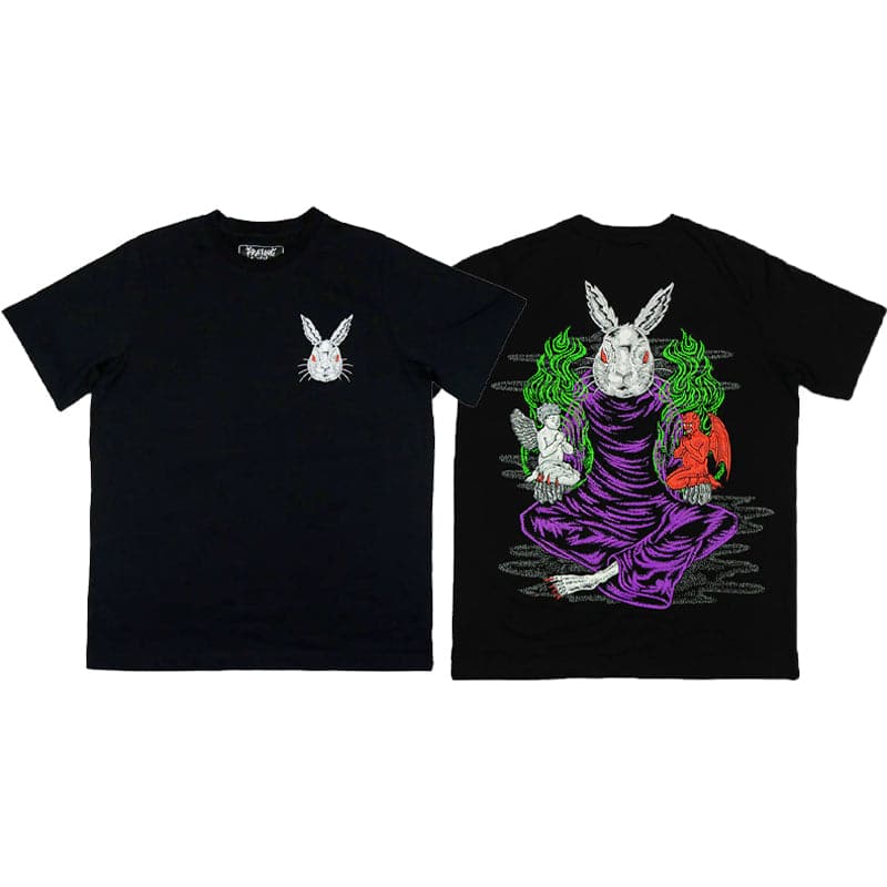 front and back view of black t shirt that shows rabbit on the left chest and a huge printed design on the back which shows an evil looking rabbit sitting down with its legs crossed. the evil rabbit is holding a demon in one hand and an angel in the other hand