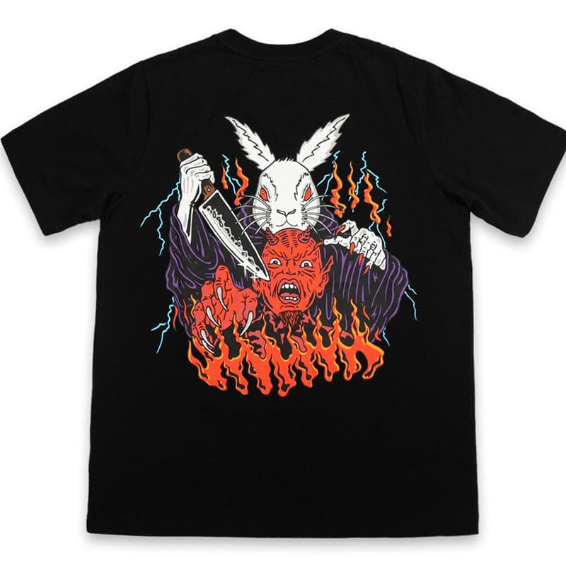 back view of black shirt that shows white rabbit wearing purple robes holding a knife about to stab the screaming demon in front of him