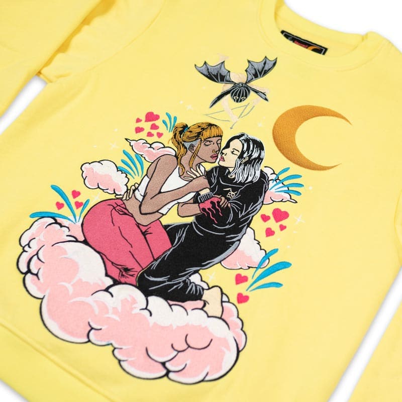 embroidered crew neck that shows two girls hugging each other on a pink cloud. above them is a rabbit cupid shooting an arrow at them and the crescent moon is behind them