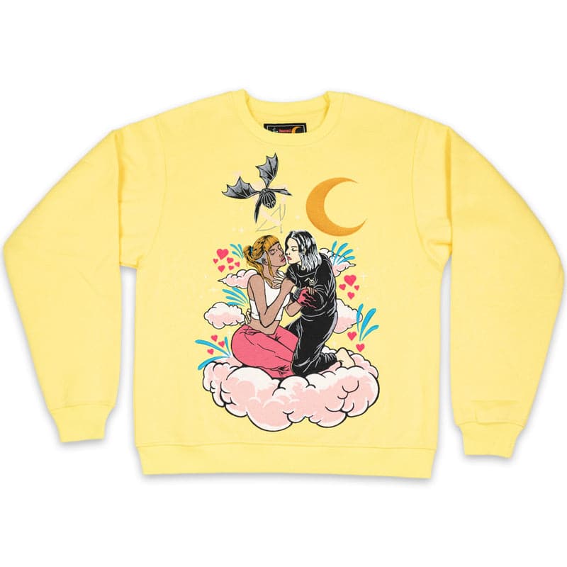 yellow crew neck with large embroidered design that shows two girls hugging each other on a cloud