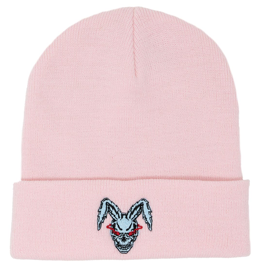 pink beanie with an embroidered design of a blue rabbit skull with red glowing eyes