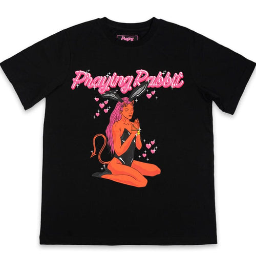 red demon girl with rabbit ears praying. she has a yellow praying rabbit rosary on her hands and pink hearts around her.