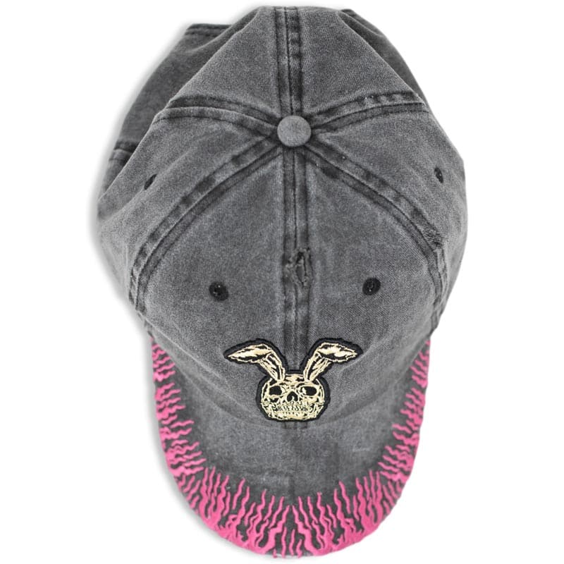 top view of vintage washed hat that shows the rabbit skull and pink flames embroidery
