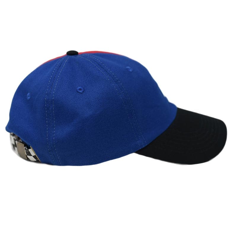 side view of hat with blue and black colors and woven label shown