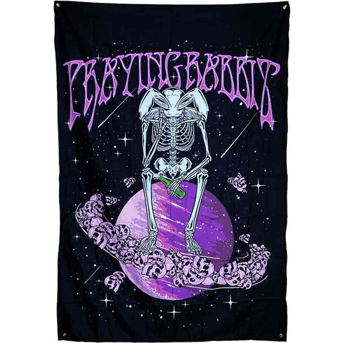 sad skeleton rabbit sitting on top of purple planet saturn that has skulls as the ring. there is a praying rabbit text in purple above the design