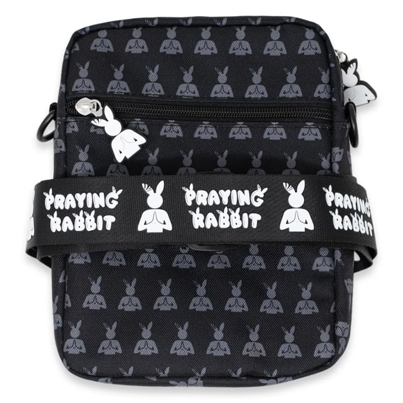 back view of the side bag that shows the praying rabbit zipper and adjustable strap