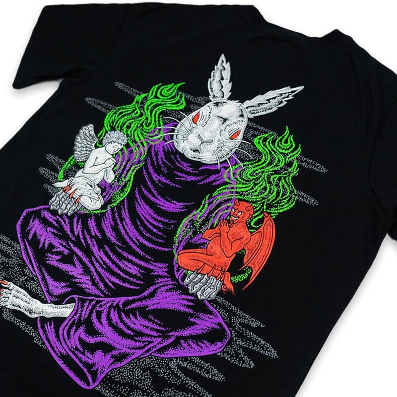 close up view that shows the rabbit holding both an angel and a demon in both hands. there are green flames arising from both characters.